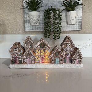 The PEPPERMINT SQUARE Led Gingerbread Village is a festive and charming addition